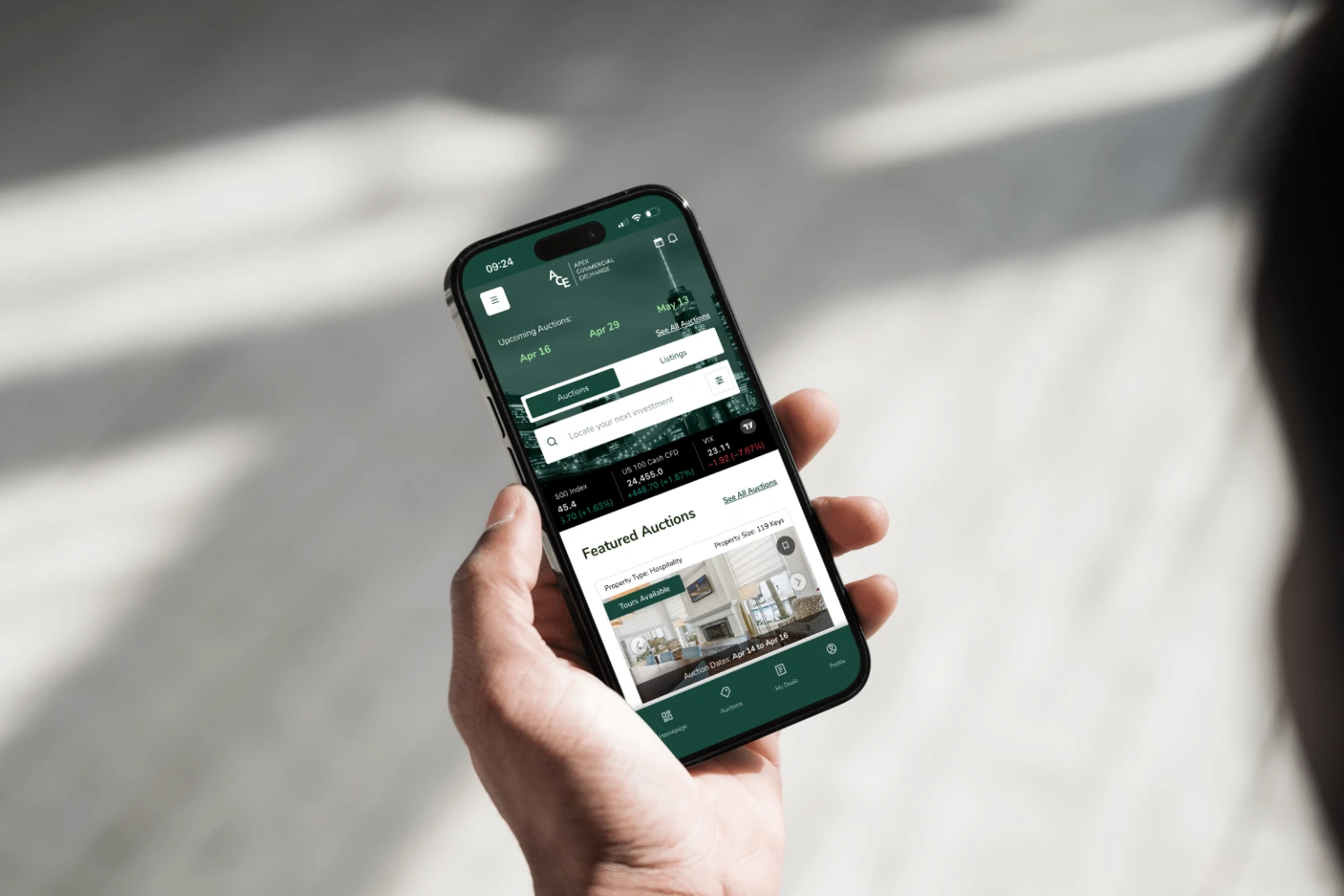 Apex Commercial Exchange mobile app showing commercial real estate listings and auction interface on smartphone